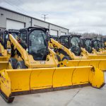 Skid loaders with snow pushers